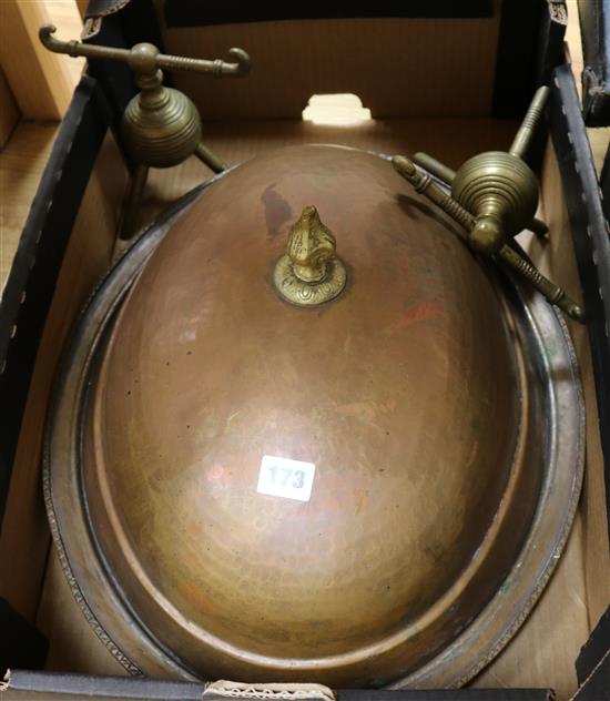 A copper serving dish and a pair of brass dogs